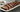 A platter of perfectly cooked fall-off-the-bone ribs with a glossy barbecue sauce glaze.